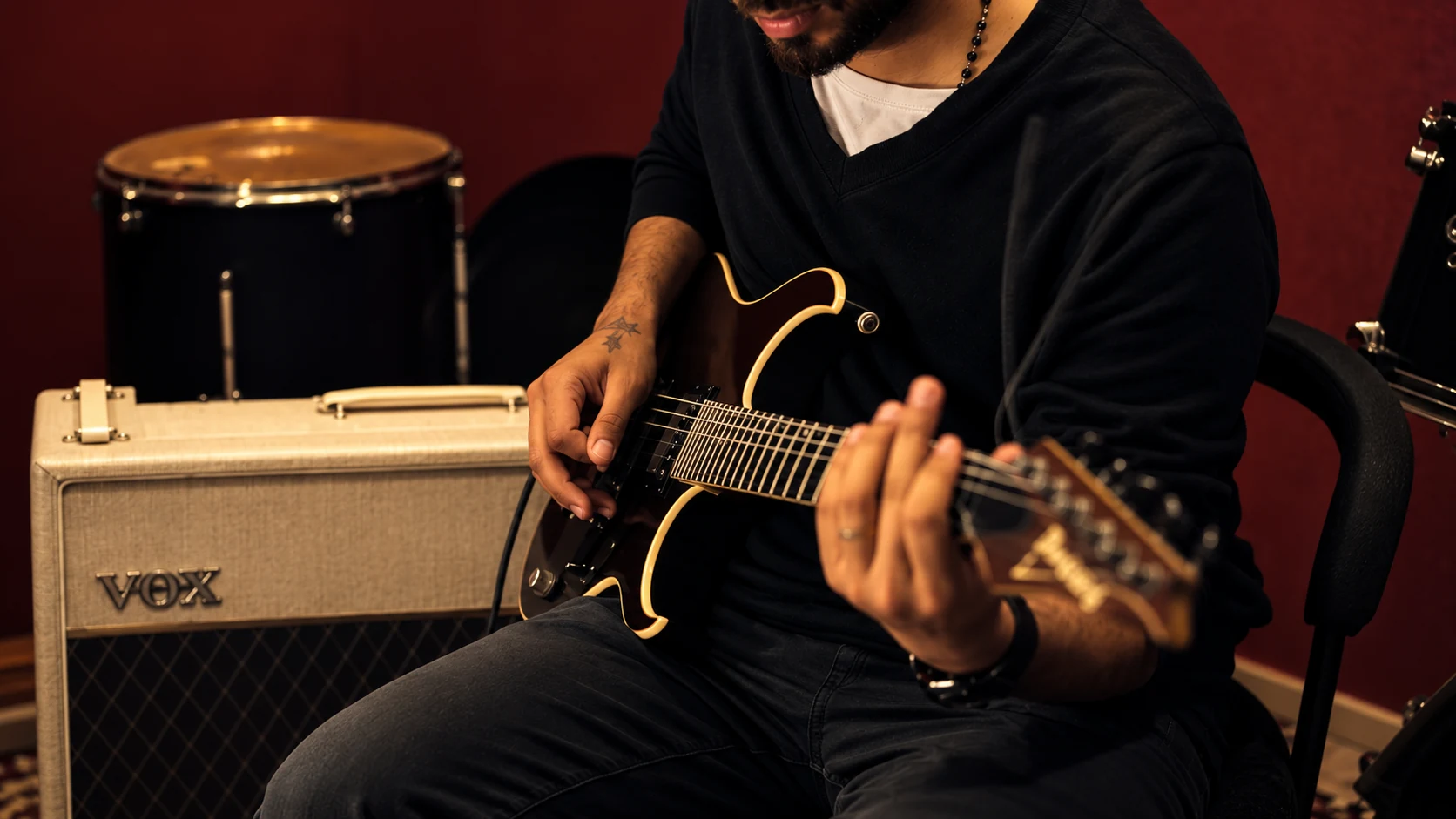 George V playing electric guitar in the studio